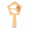 Pentagonal star-shaped natural wooden baby rattle with interactive sliding rings.