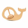 Natural wooden whale baby rattle with spinning rings on a white background.