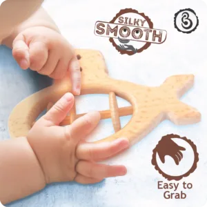 Baby's hands grasping a "silky smooth" wooden submarine toy.
