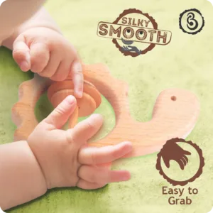 Close-up of a baby's hands grasping the silky smooth wooden turtle rattle.