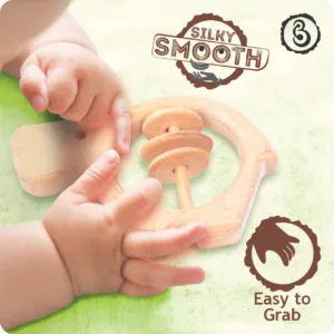 Baby's hands grasping the silky smooth wooden hippo toy.