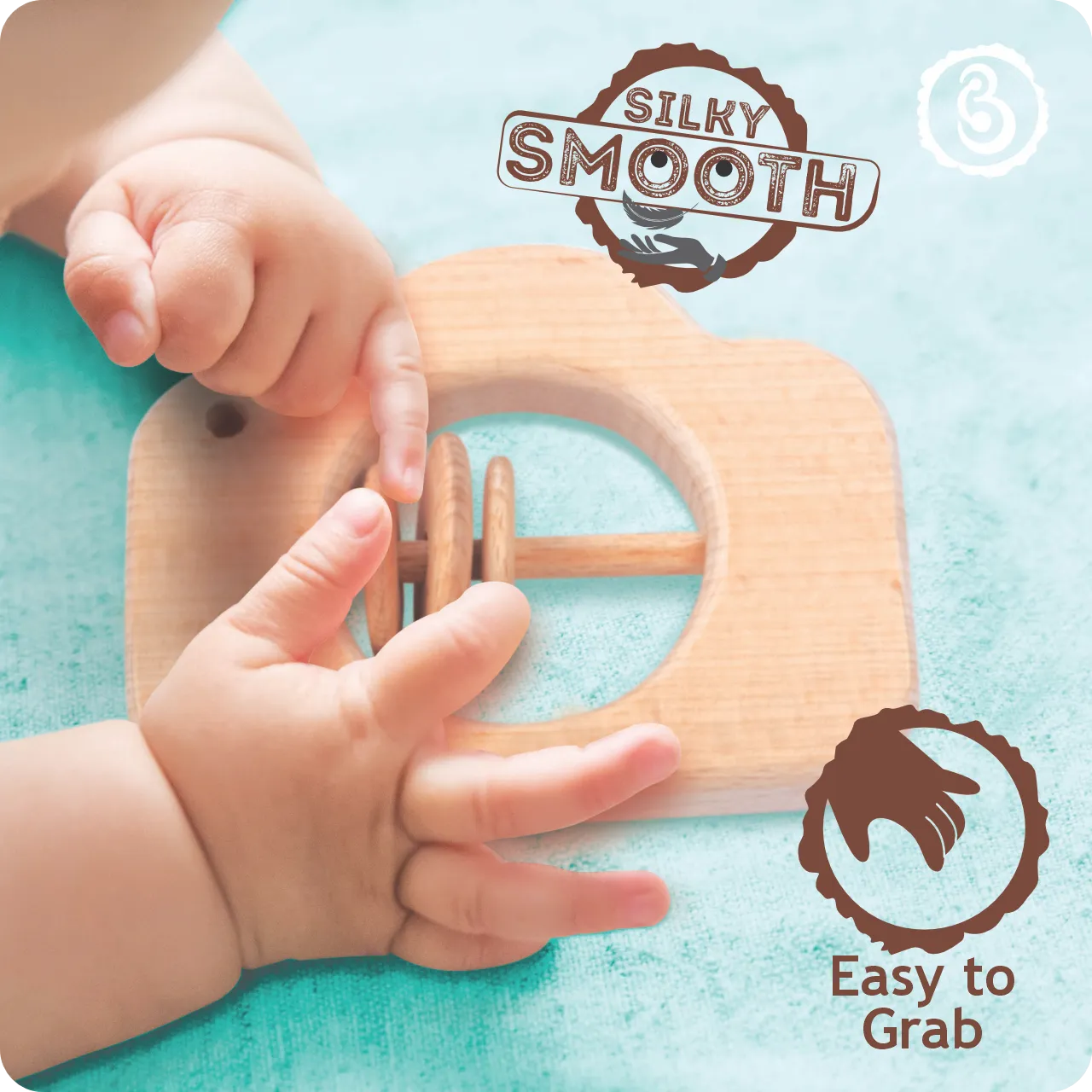 03 Baby’s hands are holding the silky smooth wooden camera rattle.
