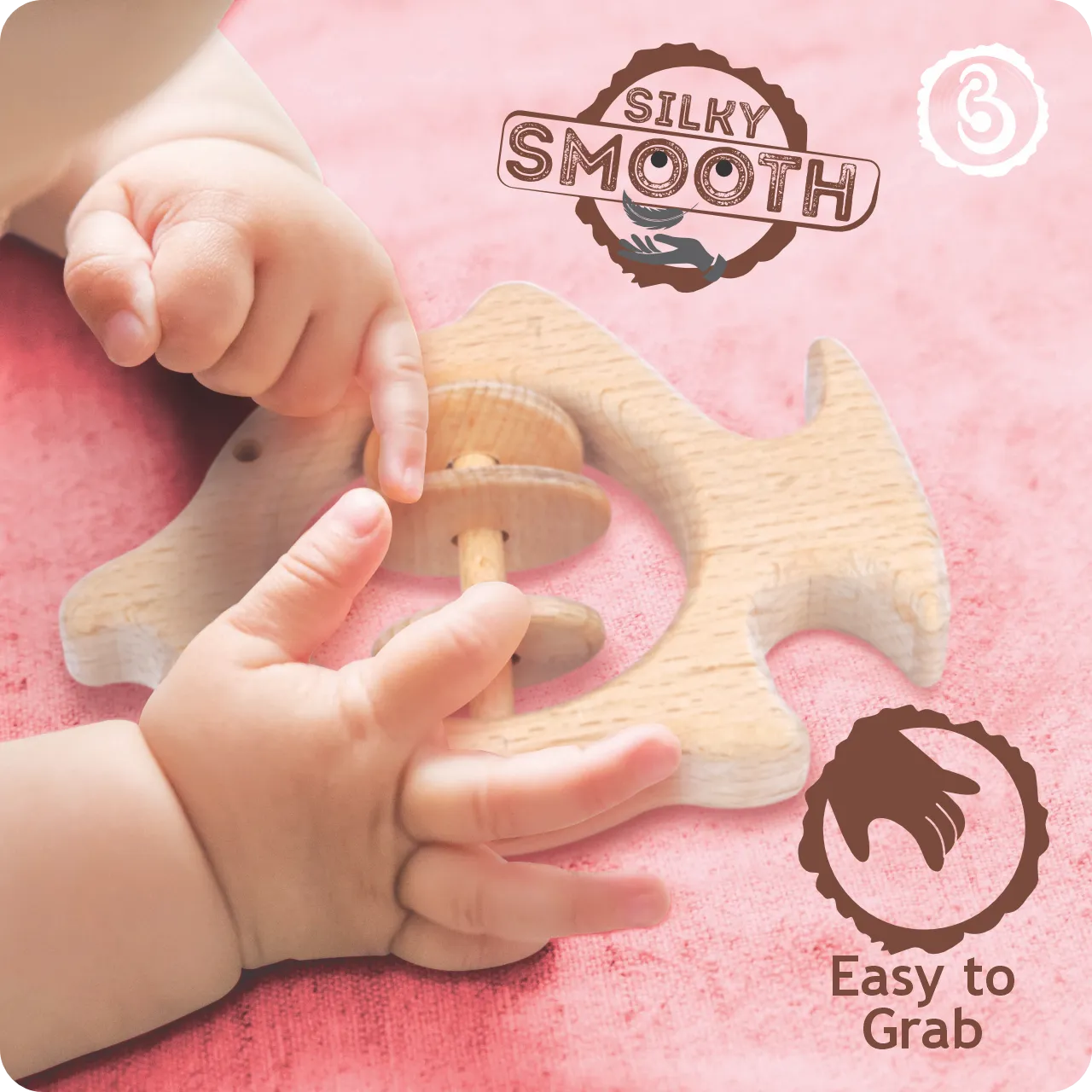 03 Baby’s hands grasping the silky smooth wooden fish-shaped rattle.