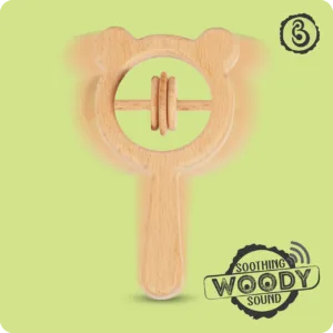 A motion-blurred wooden rattle illustrating a gentle "soothing woody sound."