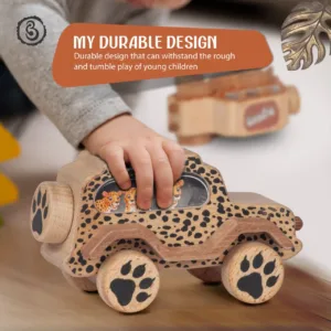 A child handling a cheetah-print wooden toy car with a brown banner.