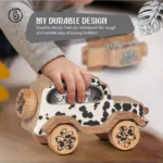 dog 03 A black and white spotted wooden dog car with a grey durability banner.