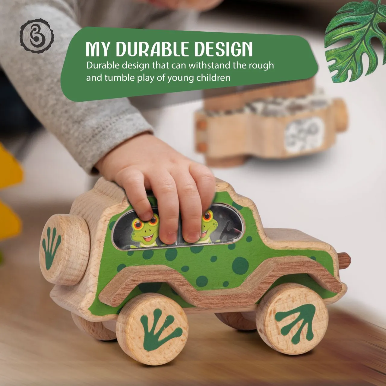 frog 03 A green, spotted frog wooden toy car under the hand of a child.