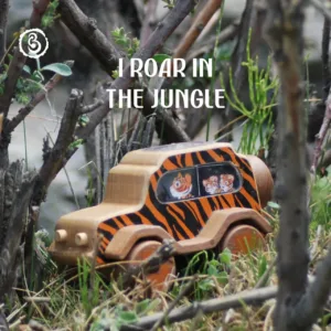 Hand grasping a wooden tiger car with a red durability banner.