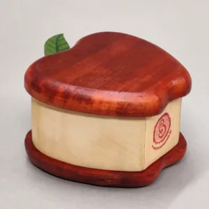 Apple-shaped wooden box viewed from a low horizontal angle.
