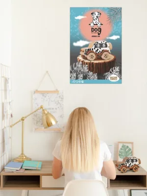 Woman sitting at a desk with a Dalmatian toy car poster displayed on the wall above.
