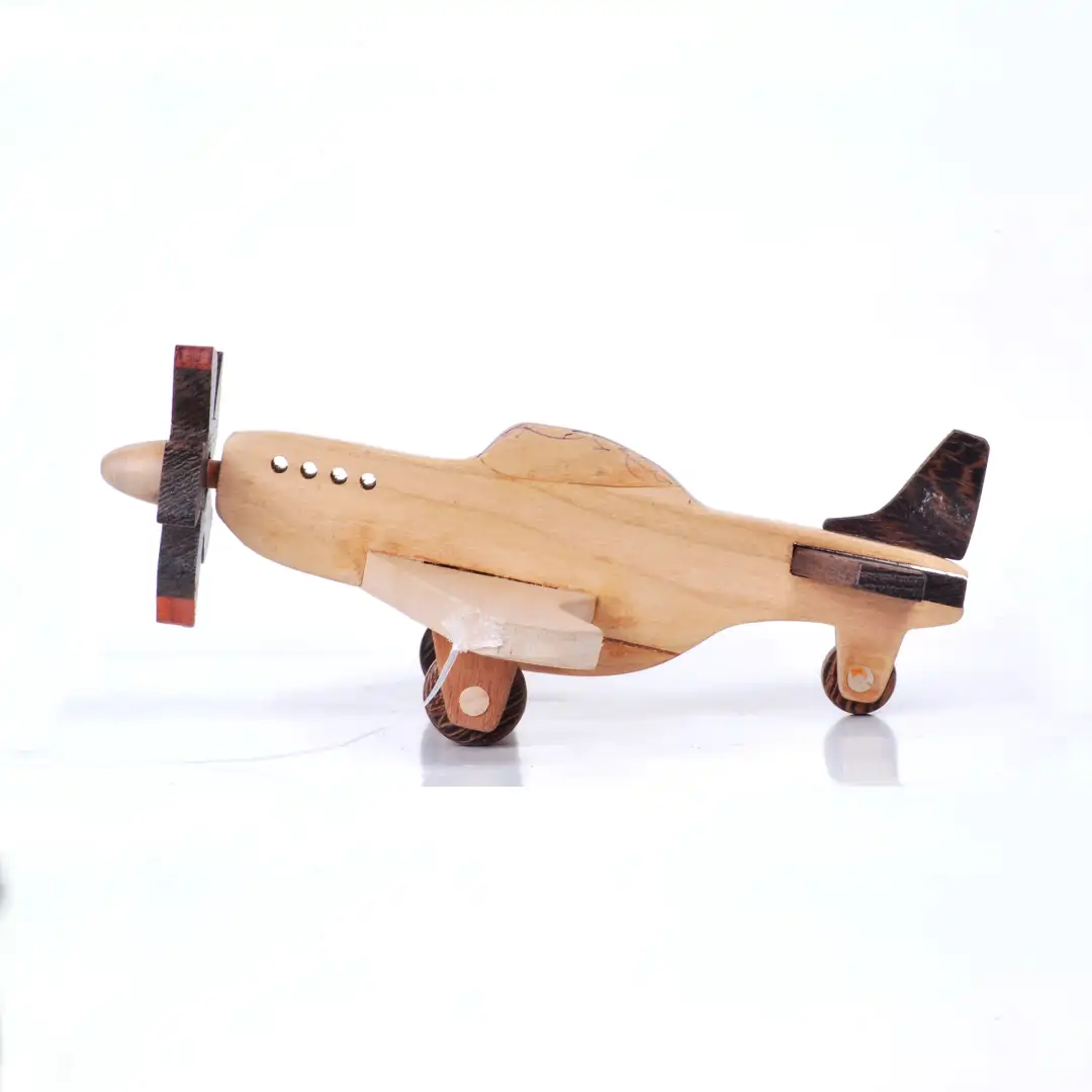 aeroplane01 Side profile of a vintage wooden toy aeroplane with a dark propeller.