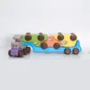Side view of a wooden car transporter truck toy with cars.