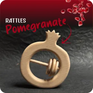 Pomegranate-shaped natural wooden baby rattle with sliding rings on a dark textured background.