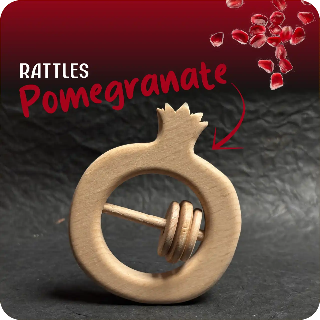 pomegranate_name Pomegranate-shaped natural wooden baby rattle with sliding rings on a dark textured background.