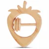 Front view of a natural wood strawberry-shaped baby rattle with carved leaf details.