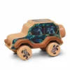Side view of a handcrafted wooden toy car with peacock feather patterns and bird claw prints on the wheels.