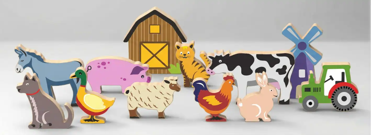 farm_grey Wooden farm animal toys in a grassy scene.