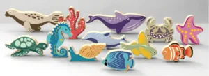 Wooden sea animals on a sandy ocean scene.