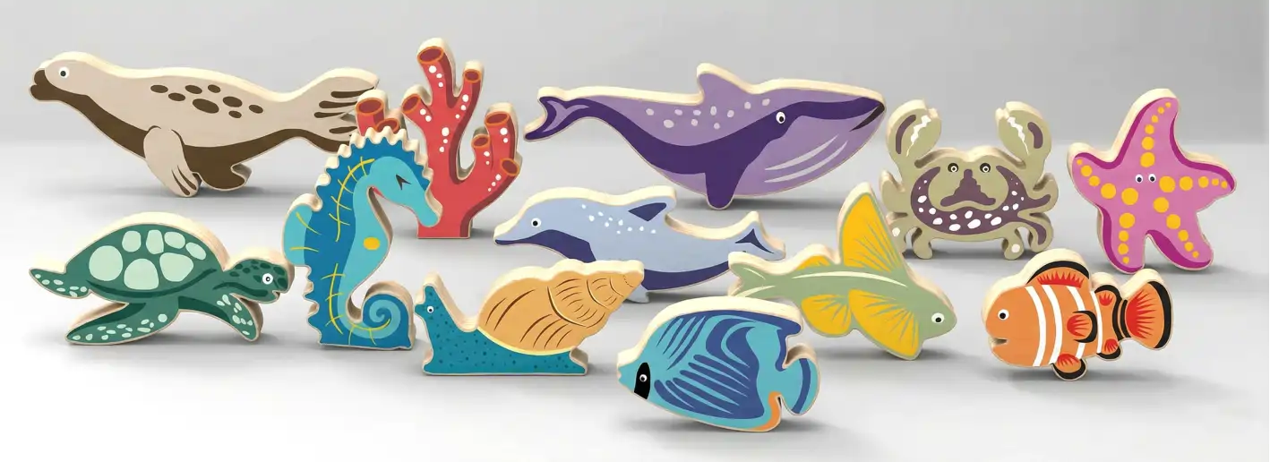 sea_grey Wooden sea animals on a sandy ocean scene.