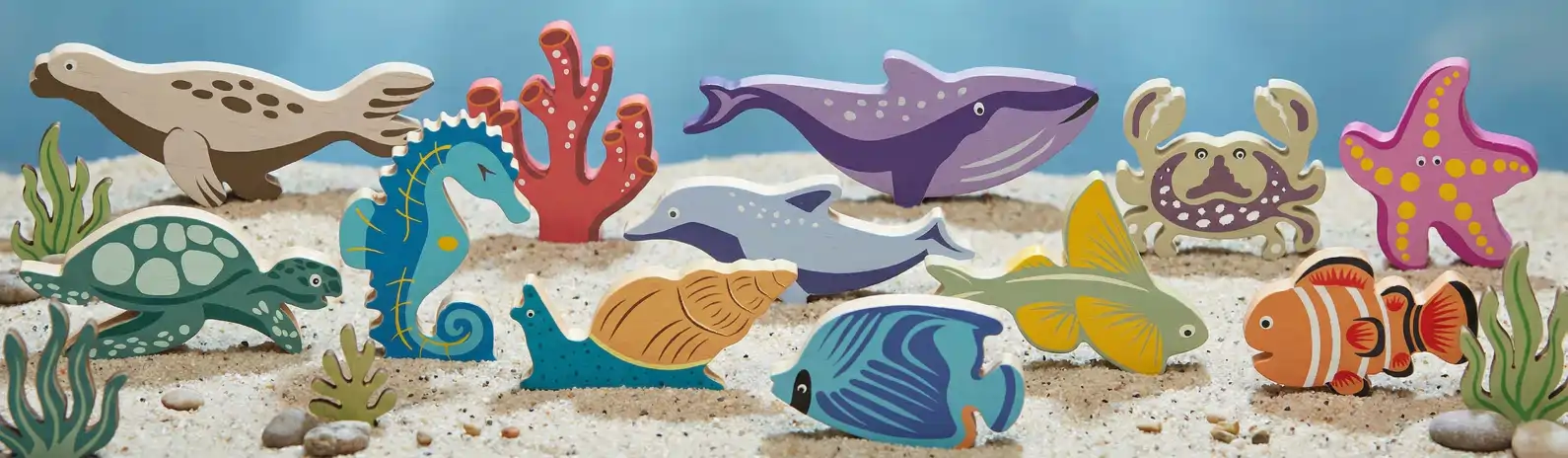 sea_scene Wooden sea animals on a sandy ocean scene.